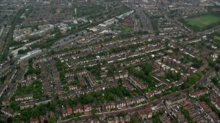 AX115_055 - 5.5K aerial stock footage of residential neighborhoods in the rain, London, England