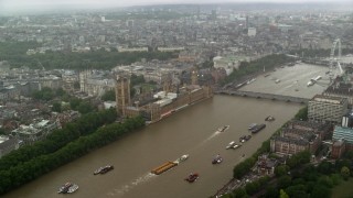 AX115_072 - 5.5K aerial stock footage approach Big Ben and Parliament from River Thames in the rain, London, England