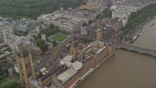 AX115_072E - 5.5K aerial stock footage fly over Big Ben and Parliament toward Treasury and Foreign Office in the rain, London, England