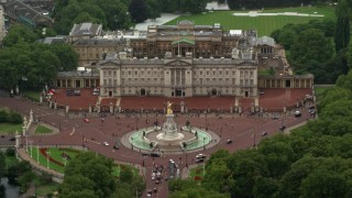 AX115_075 - 5.5K stock footage aerial video of Buckingham Palace and Victoria Memorial in the rain, London, England