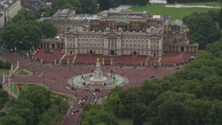 AX115_075E - 5.5K aerial stock footage of Buckingham Palace and Victoria Memorial in the rain, London, England
