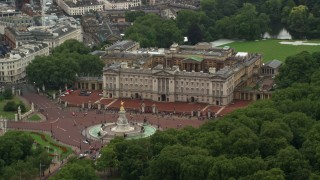 AX115_076 - 5.5K aerial stock footage of orbiting Buckingham Palace and Victoria Memorial while raining, London, England