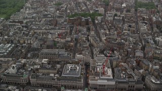 AX115_077 - 5.5K aerial stock footage tilt from office buildings in the rain to wider view of the city, London, England