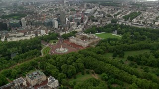 AX115_079 - 5.5K stock footage aerial video approach Buckingham Palace in the rain, London, England