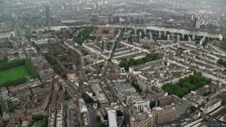 AX115_081 - 5.5K aerial stock footage of orbiting apartment buildings and city streets in the rain, London, England
