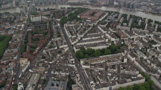 AX115_081E - 5.5K aerial stock footage of apartment buildings and city streets in the rain, London, England