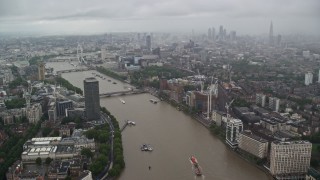 AX115_083E - 5.5K aerial stock footage of River Thames winding through the city while raining, London, England