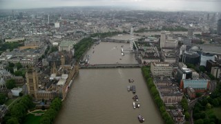 AX115_087 - 5.5K aerial stock footage of Westminster Bridge while following River Thames past Parliament, London, England