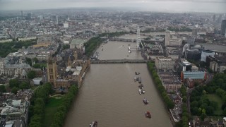 AX115_087E - 5.5K aerial stock footage of Westminster Bridge while following River Thames past Parliament, London, England