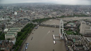 AX115_088 - 5.5K aerial stock footage of Hungerford Bridge while flying over River Thames near London Eye, England