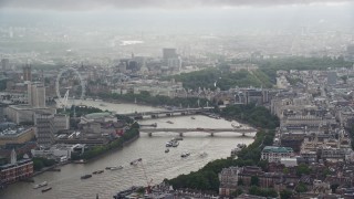 AX115_095 - 5.5K aerial stock footage video of Waterloo Bridge over the River Thames near London Eye, England