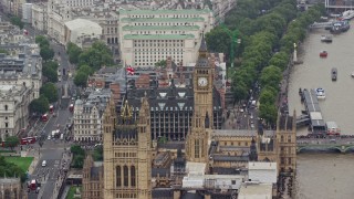 AX115_103E - 5.5K aerial stock footage of British Flag atop Parliament reveal Big Ben, London England