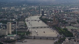 AX115_116E - 5.5K aerial stock footage of Big Ben and London Eye, and bridges spanning River Thames, England