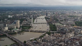 AX115_118E - 5.5K aerial stock footage approach bridges over the River Thames and London Eye, England