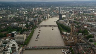 AX115_122 - 5.5K aerial stock footage of flying over bridges spanning the River Thames through London, England