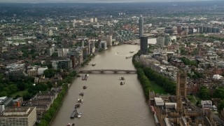 AX115_123 - 5.5K aerial stock footage of approaching Lambeth Bridge spanning the River Thames through London, England