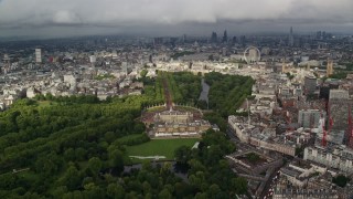 AX115_129 - 5.5K aerial stock footage of orbiting Buckingham Palace with a cityscape view, London, England