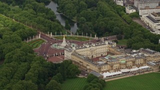 AX115_130E - 5.5K aerial stock footage orbiting Buckingham Palace and Victoria Memorial, London, England