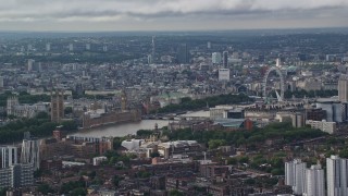 AX115_147 - 5.5K aerial stock footage of city sprawl behind Parliament and London Eye, England
