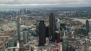 AX115_158 - 5.5K aerial stock footage of an orbit of a group of skyscrapers in Central London, England