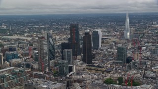 AX115_160E - 5.5K aerial stock footage of a view of skyscrapers and The Shard, Central London, England