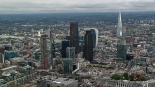 AX115_161 - 5.5K aerial stock footage of The Shard behind tall skyscrapers and cityscape, Central London, England