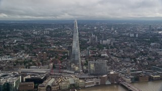 AX115_177E - 5.5K aerial stock footage of a wide orbit of The Shard and cityscape, London, England