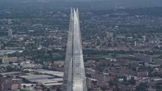AX115_180E - 5.5K aerial stock footage of orbiting the top of The Shard, London, England