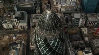 AX115_191 - 5.5K stock footage aerial video tilt to bird's eye view of The Gherkin skyscraper, Central London, England