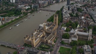 AX115_199 - 5.5K stock footage aerial video orbiting Big Ben, Parliament and Westminster Abbey by the Thames in London, England