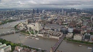 AX115_200 - 5.5K stock footage aerial video of London Eye and River Thames against the cityscape, London, England