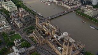AX115_201 - 5.5K stock footage aerial video orbit above Big Ben and Parliament beside the River Thames, London, England