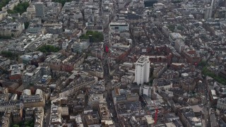 AX115_207E - 5.5K aerial stock footage of city buildings surrounding Long Acre Charing Cross Road, London, England