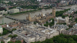 AX115_212 - 5.5K stock footage aerial video approach Big Ben, Parliament and government offices on the Thames, London, England