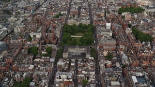 AX115_228E - 5.5K aerial stock footage approach United States Embassy among office buildings, London, England