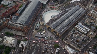 AX115_238 - 5.5K aerial stock footage of tilting to bird's eye of Kings Cross Train Station, London, England