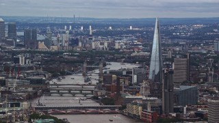AX115_246E - 5.5K aerial stock footage of The Shard, and Tower Bridge spanning the Thames among cityscape, London, England
