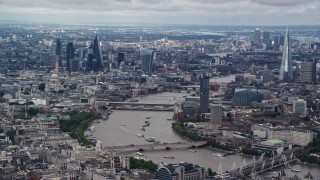 AX115_250E - 5.5K aerial stock footage of a wide view of the cityscape, from Central London to Shard by River Thames, England