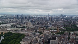 AX115_256E - 5.5K aerial stock footage of the cityscape, the London Eye, and Parliament, England