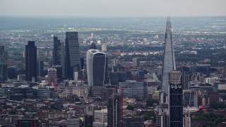 AX115_275E - 5.5K aerial stock footage of Central London skyscrapers, The Shard and Strata in foreground, England