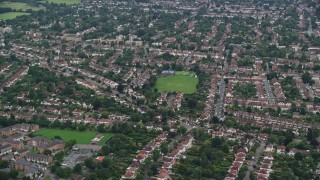 AX115_293E - 5.5K aerial stock footage of a residential neighborhood, Wallington, England