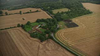 AX115_308 - 5.5K aerial stock footage of orbiting a farm and fields, Redhill, England