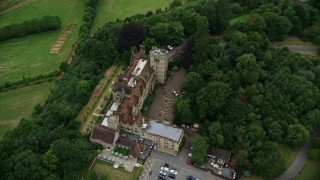 AX115_315E - 5.5K aerial stock footage of Nutfield Priory Hotel with trees, Redhill, England