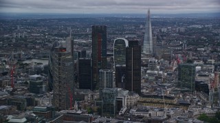 AX116_015E - 5.5K aerial stock footage orbit and approach skyscrapers, The Shard near River Thames, London, England, twilight