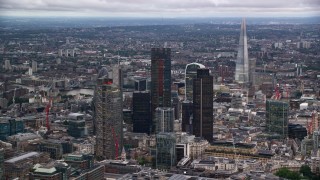 AX116_016 - 5.5K aerial stock footage of skyscrapers, with The Shard in distance, London, England, twilight
