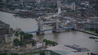 AX116_020 - 5.5K aerial stock footage of flying by Tower Bridge spanning the River Thames in London, England, twilight