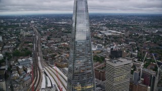 AX116_021E - 5.5K aerial stock footage of flying by The Shard skyscraper in London, England, twilight