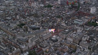 AX116_031E - 5.5K aerial stock footage of flying by Piccadilly Circus, London, England, twilight