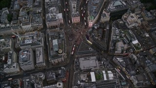 AX116_037E - 5.5K aerial stock footage of a bird's eye view over Piccadilly Circus and double decker buses, London, England, twilight