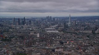 AX116_049 - 5.5K aerial stock footage of a view of the River Thames and Central London skyscrapers, England, twilight